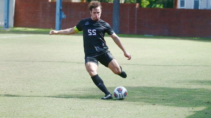 Jacob Galan kicks a soccer ball during a Trinity home game