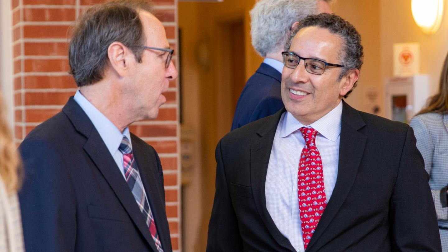 Juan Sepulveda and Danny Anderson speak in the Northrup Hall lobby