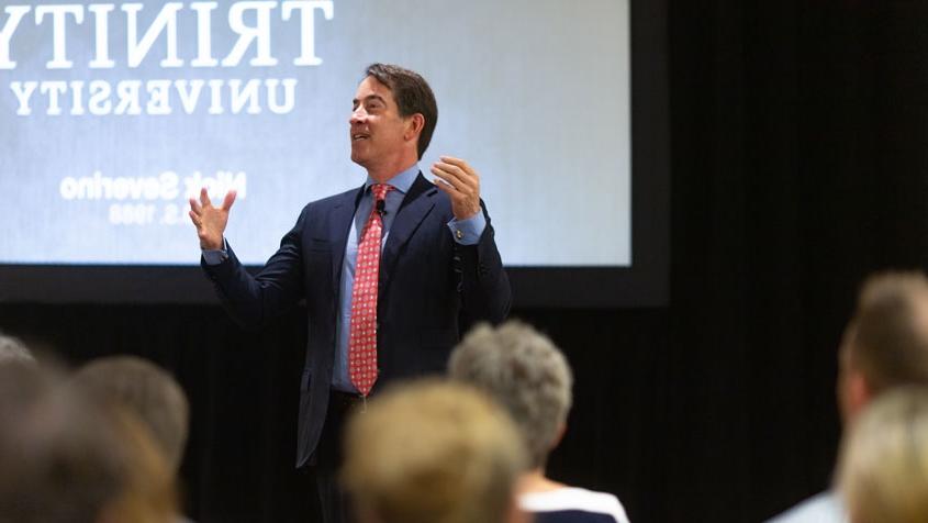 Nick Severino walks around the room in front of an audience. 